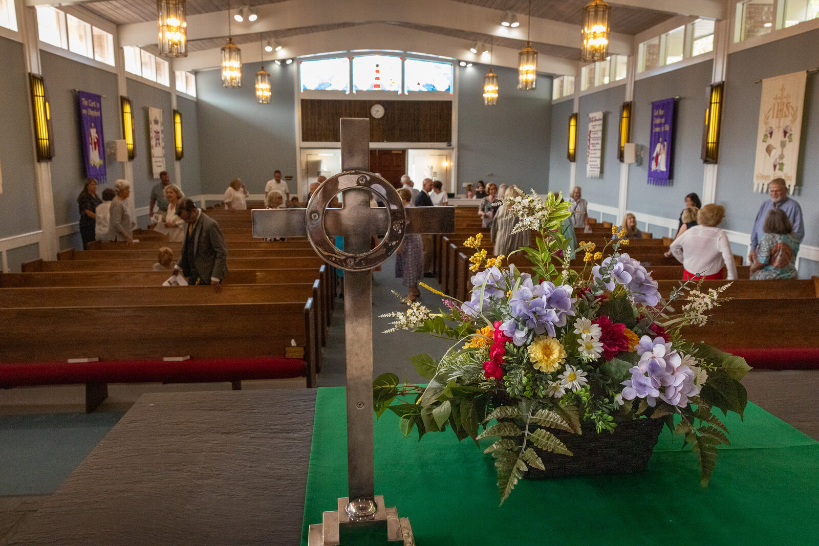 The sanctuary at Harbor View Presbyterian after Sunday worship, communion cross in the foreground